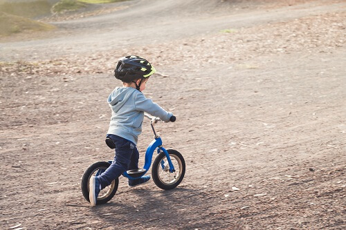 kid on balance bike.webp